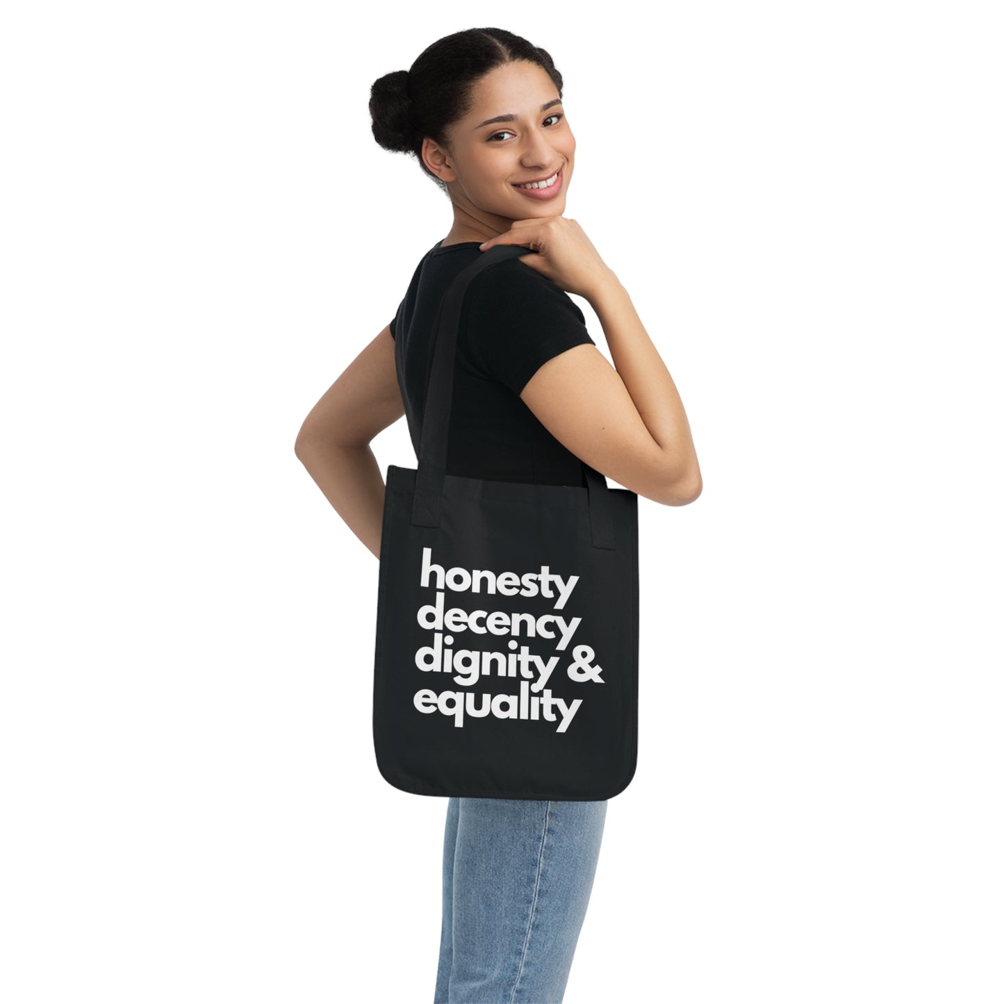 Person wearing a black tote bag with 'honesty decency dignity & equality' text on a white background