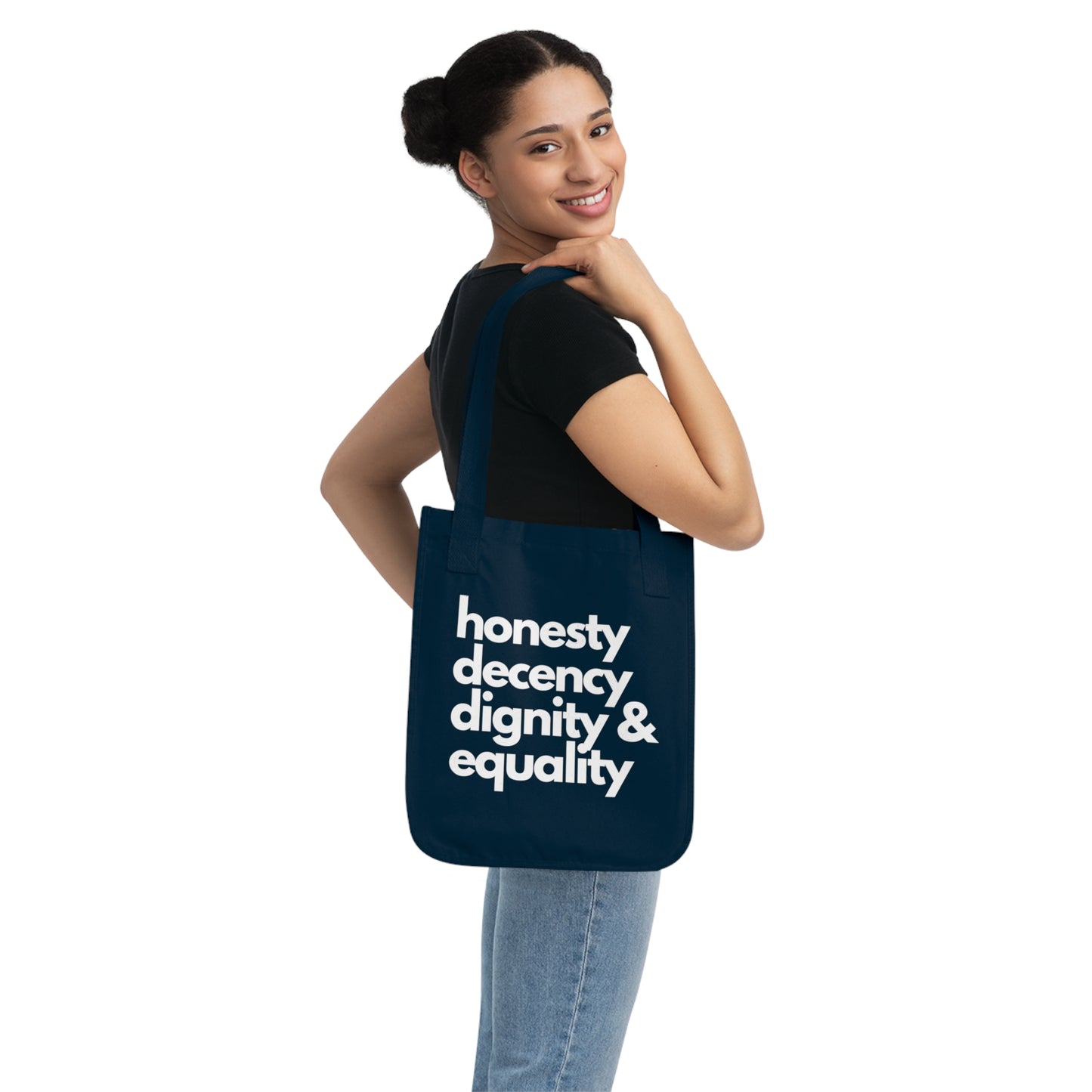 Woman holding a navy blue tote bag with text on a white background